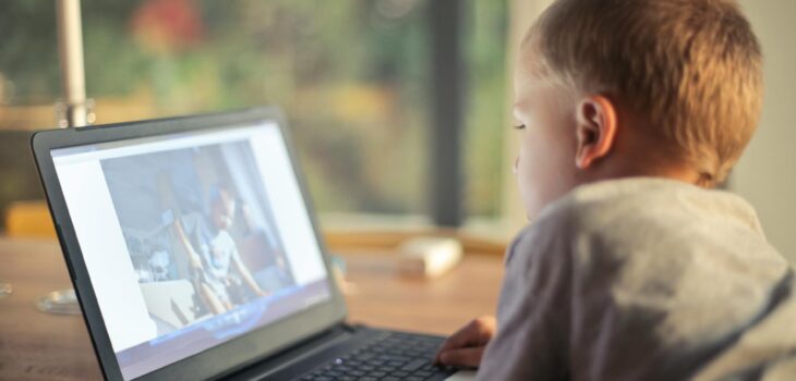 boy watching video using laptop